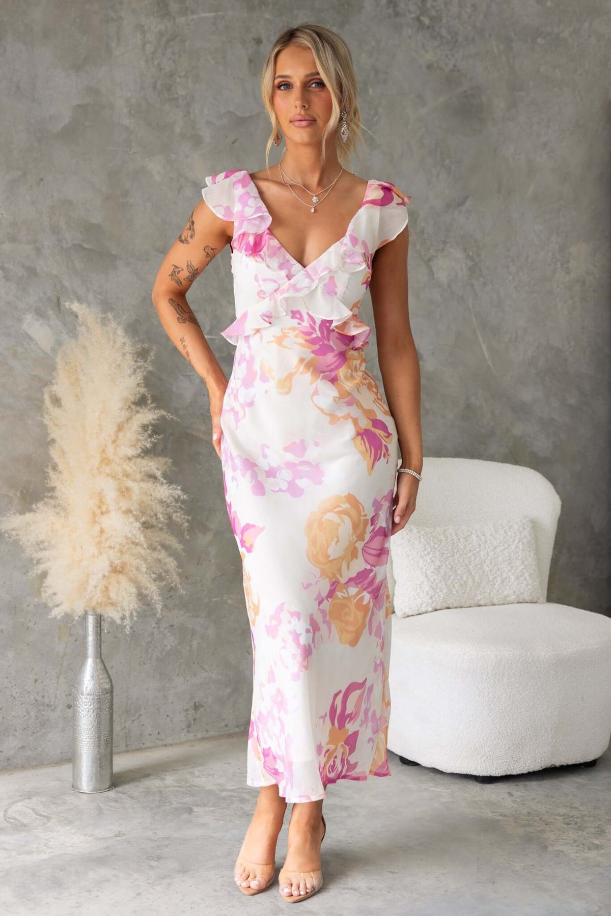 Bonnet Maxi Dress with ruffle details and V-neckline, worn by a model in a floral chiffon design.