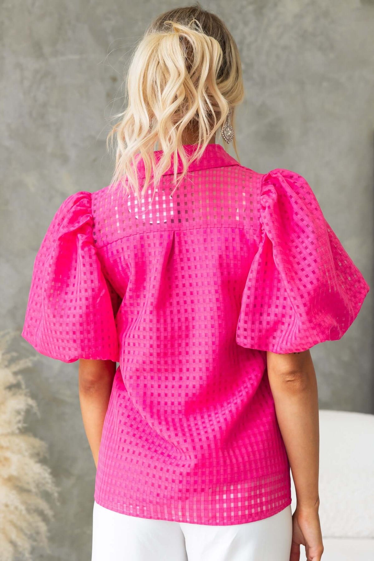Ursa Shirt in vibrant pink with puff sleeves, textured material, and button-up details, perfect for a stylish casual look.
