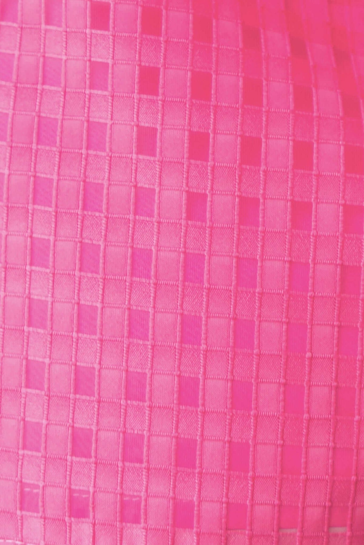 Texture detail of the Ursa Shirt, featuring a vibrant pink checkered pattern.
