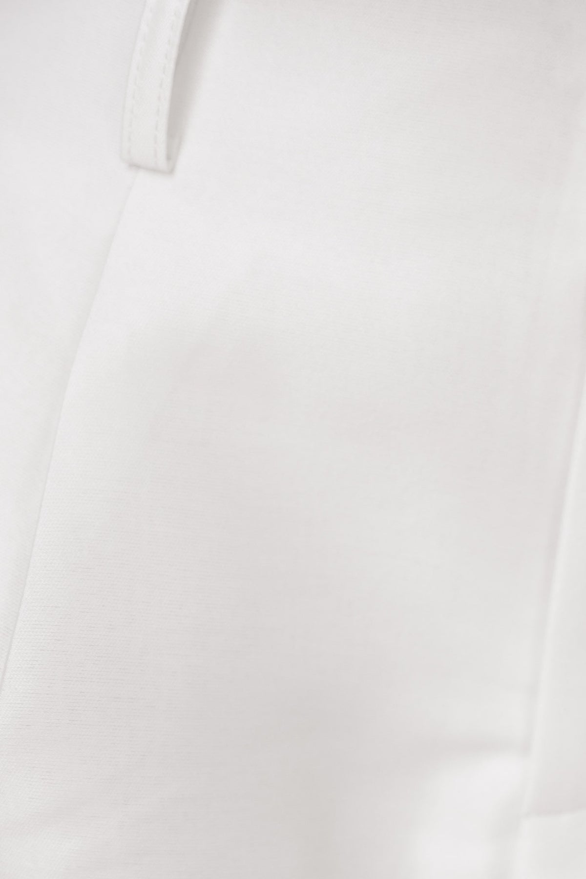 Close-up of Penelope Shorts in white, showcasing smooth fabric, mid-high waist design, and subtle sheen.