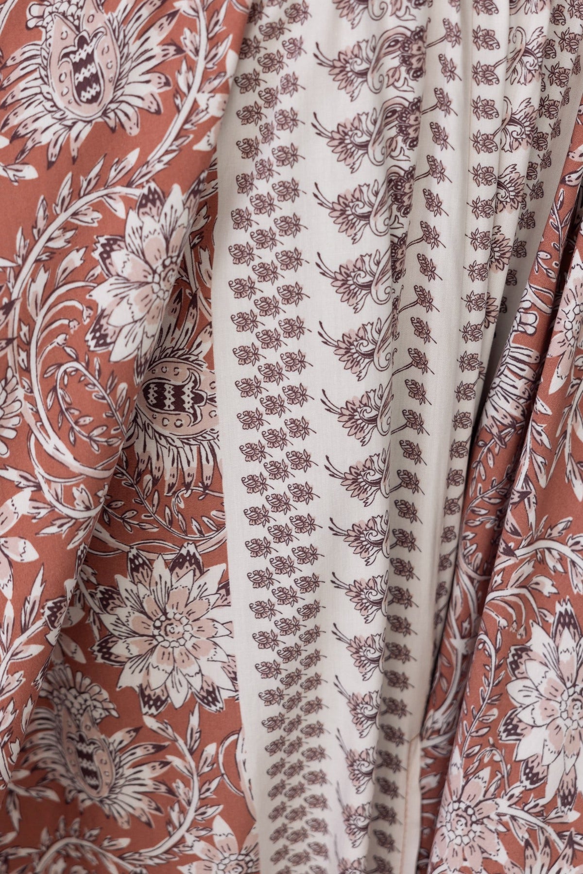 Close-up view of the abstract print fabric of the Relly Maxi Dress featuring floral and intricate patterns.