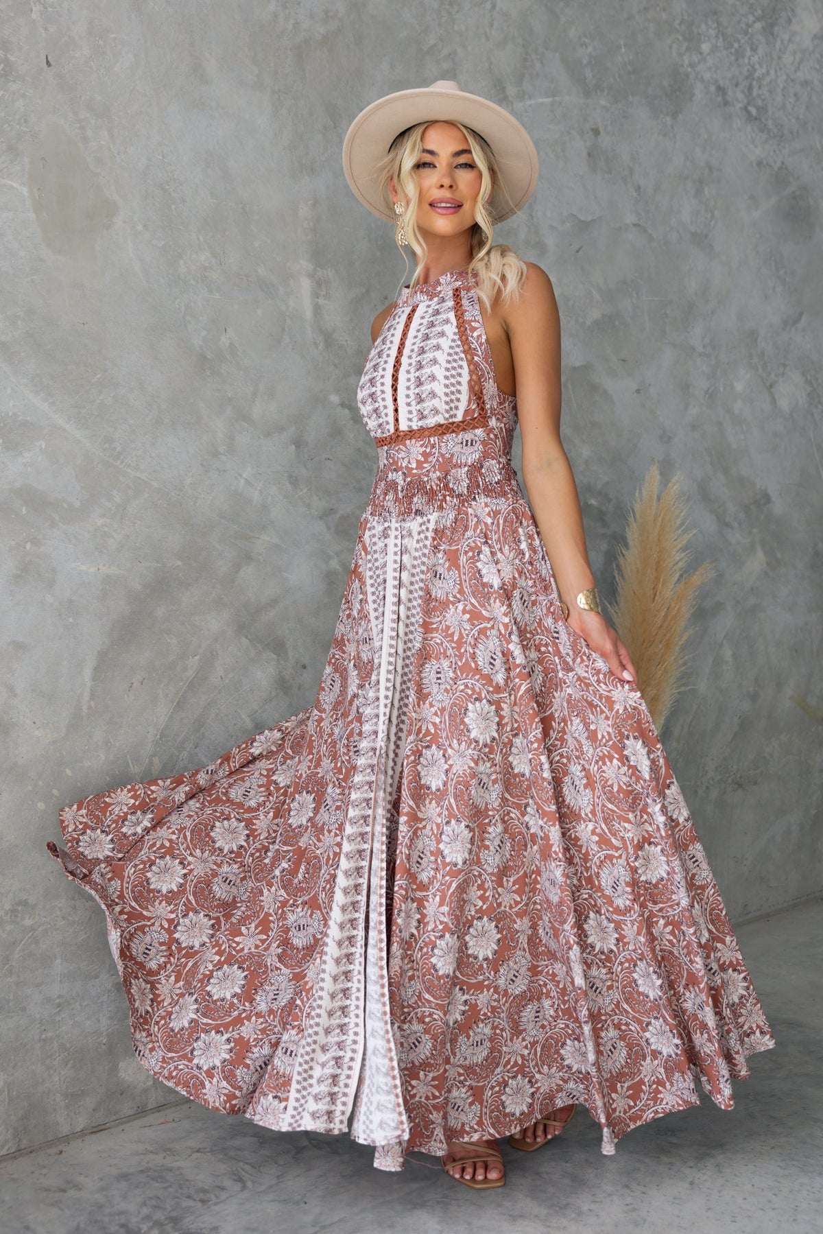 Relly Maxi Dress featuring an abstract print, high halter neckline, and split front for a flowy, stylish look.