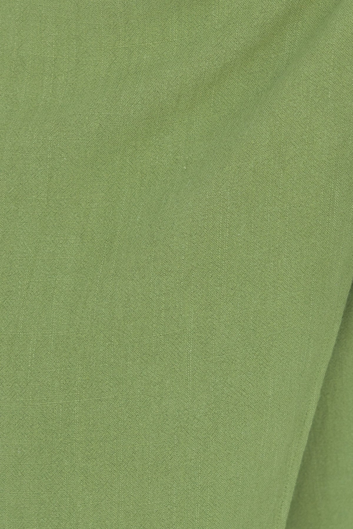 Close-up of soft green fabric texture, perfect for a Tahnee Maxi Skirt with a linen look and feel.