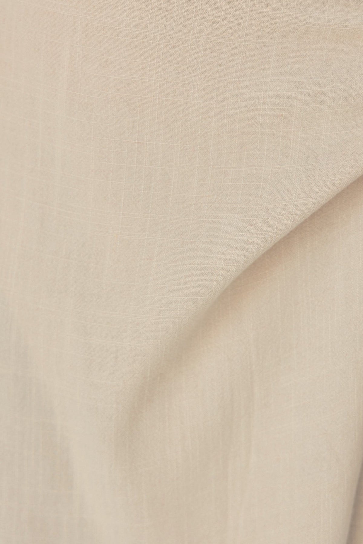 Close-up of soft, light beige fabric showcasing a linen look, perfect for a Tahnee Maxi Skirt.