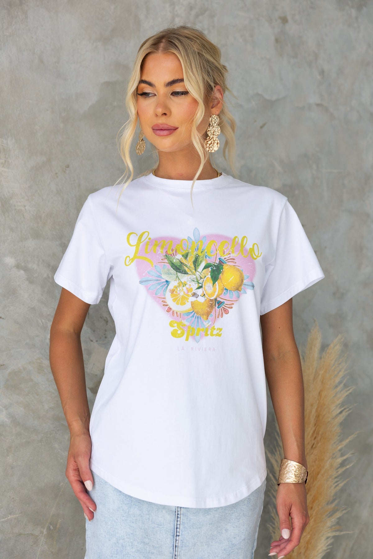 Model wearing Limocello Spritz print tee with round neckline and soft cotton feel, styled with casual accessories.