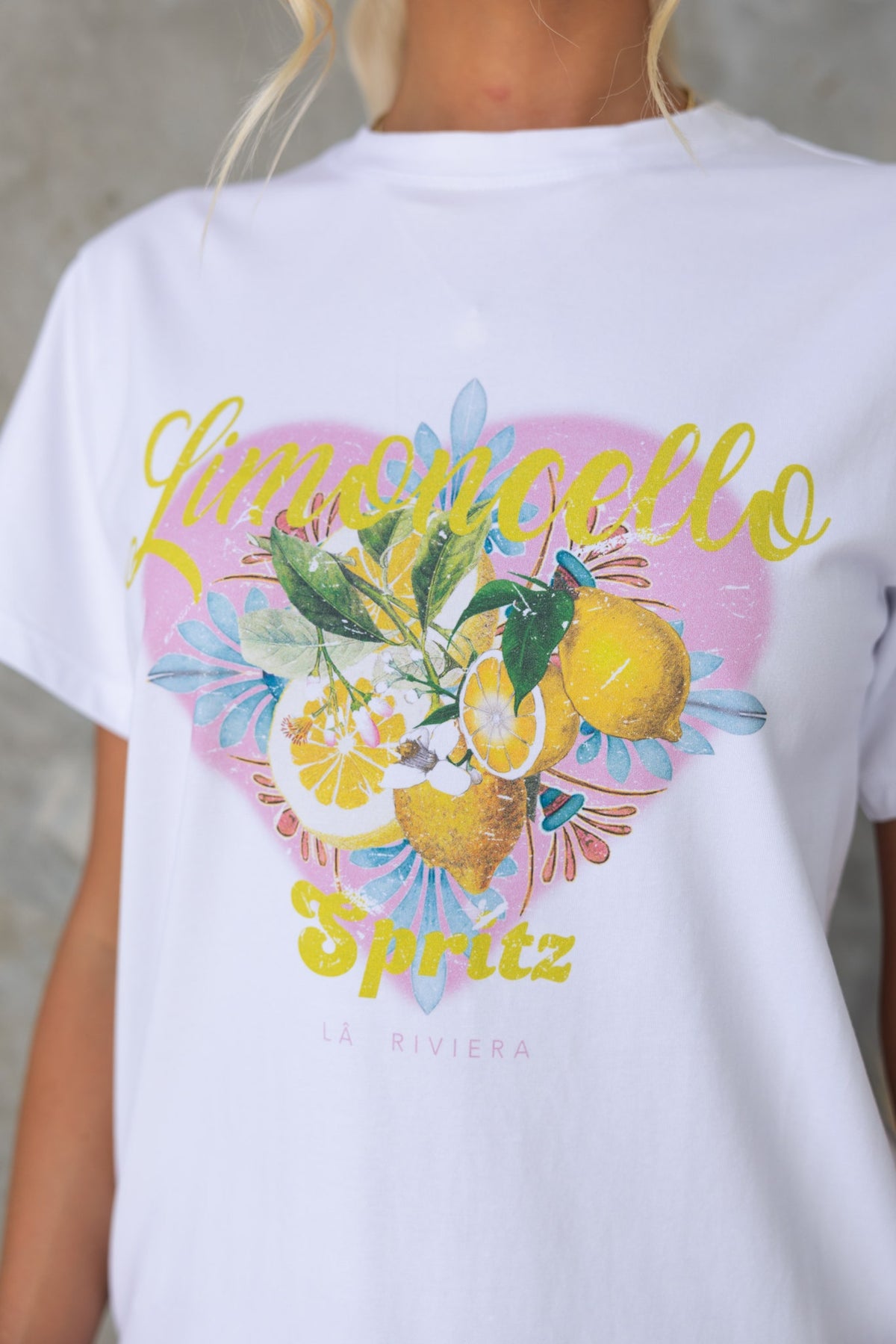 Limocello Spritz graphic tee featuring vibrant lemons and floral design, perfect for a casual, stylish look.
