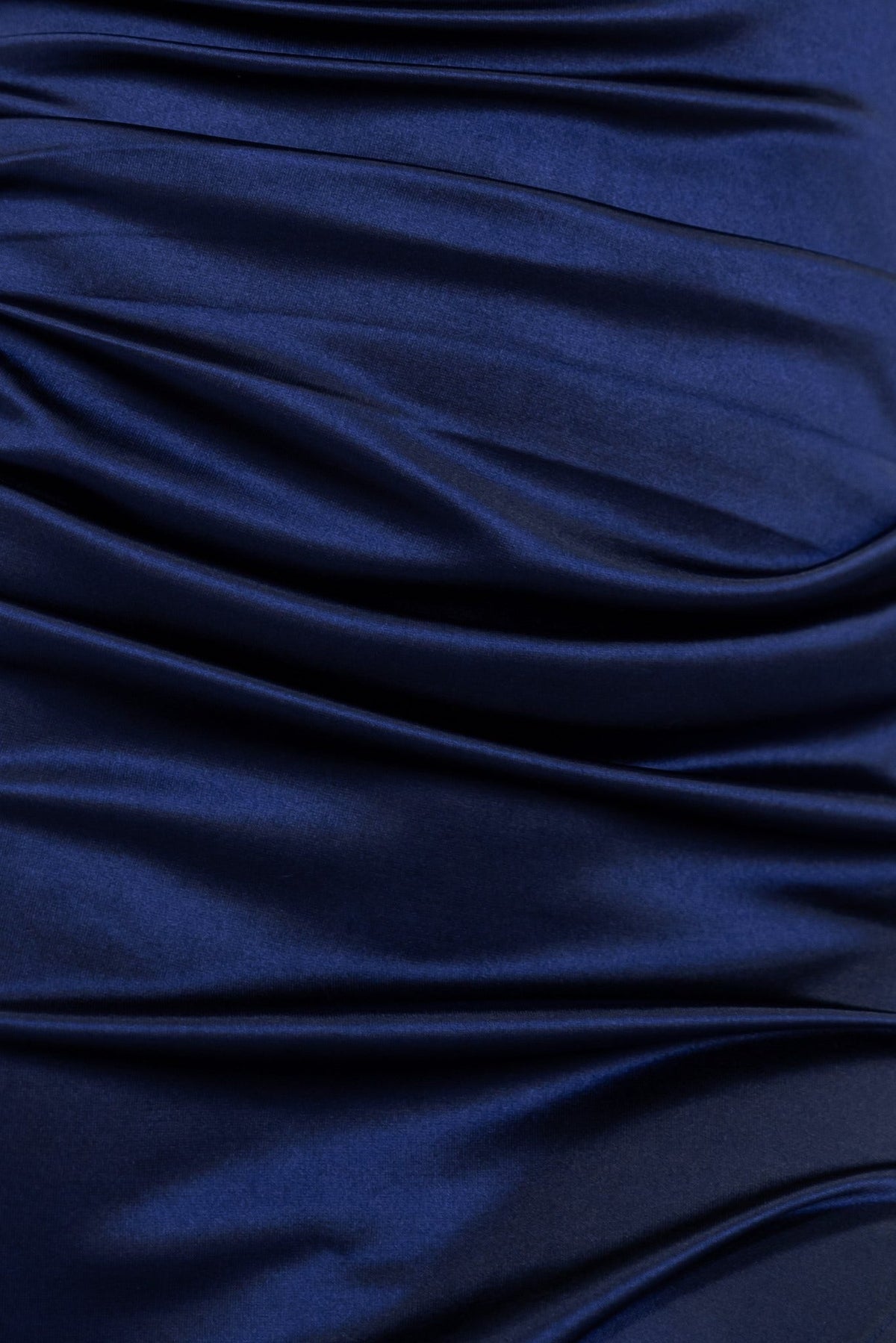 Navy blue satin fabric with gathered texture, showcasing the luxurious material of the Gaia Maxi Dress.