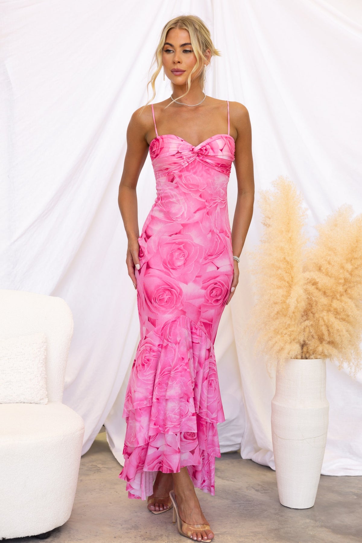 Qasila Maxi Dress in pink floral print, featuring adjustable straps, ruffle hem, and mesh overlay design.