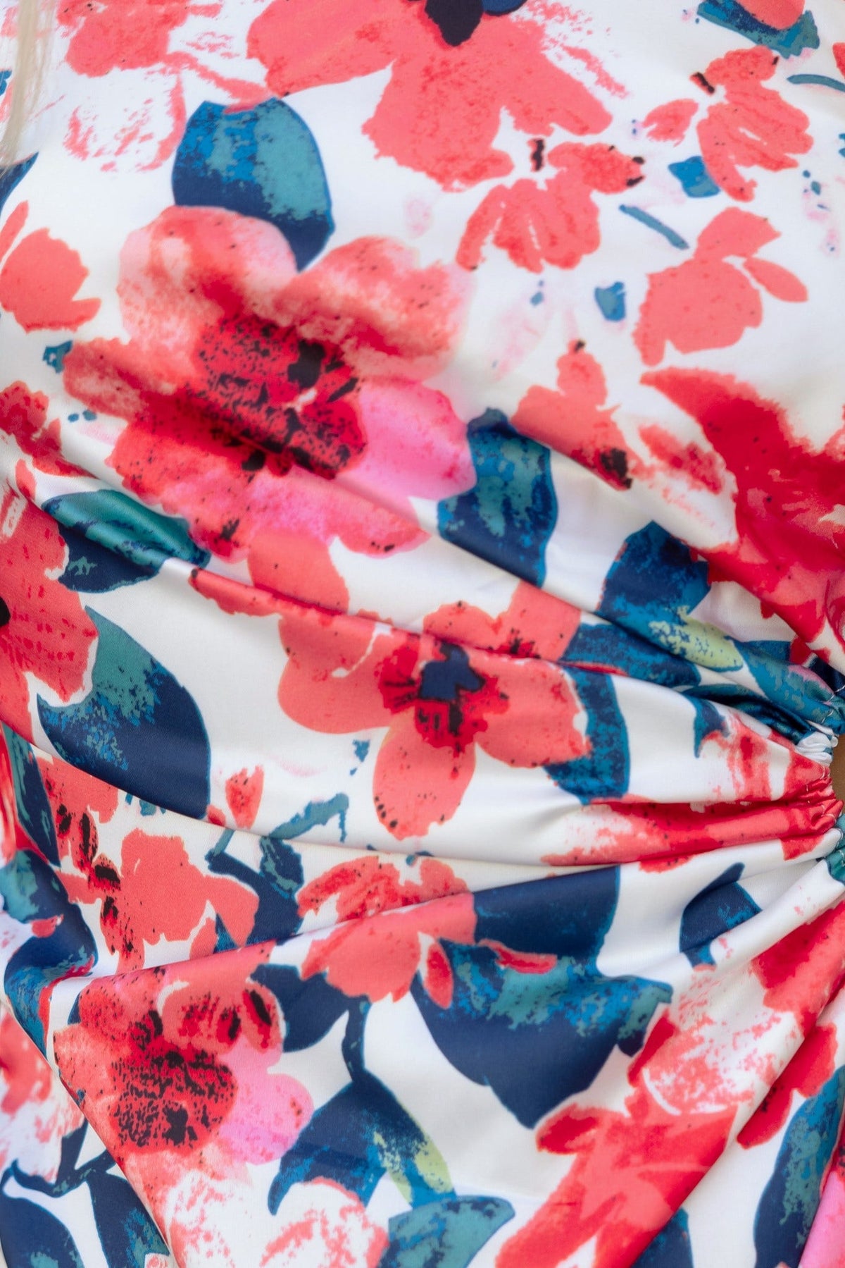 Close-up of floral print fabric on the Ronan Maxi Dress, featuring vibrant red, pink, and blue flowers.