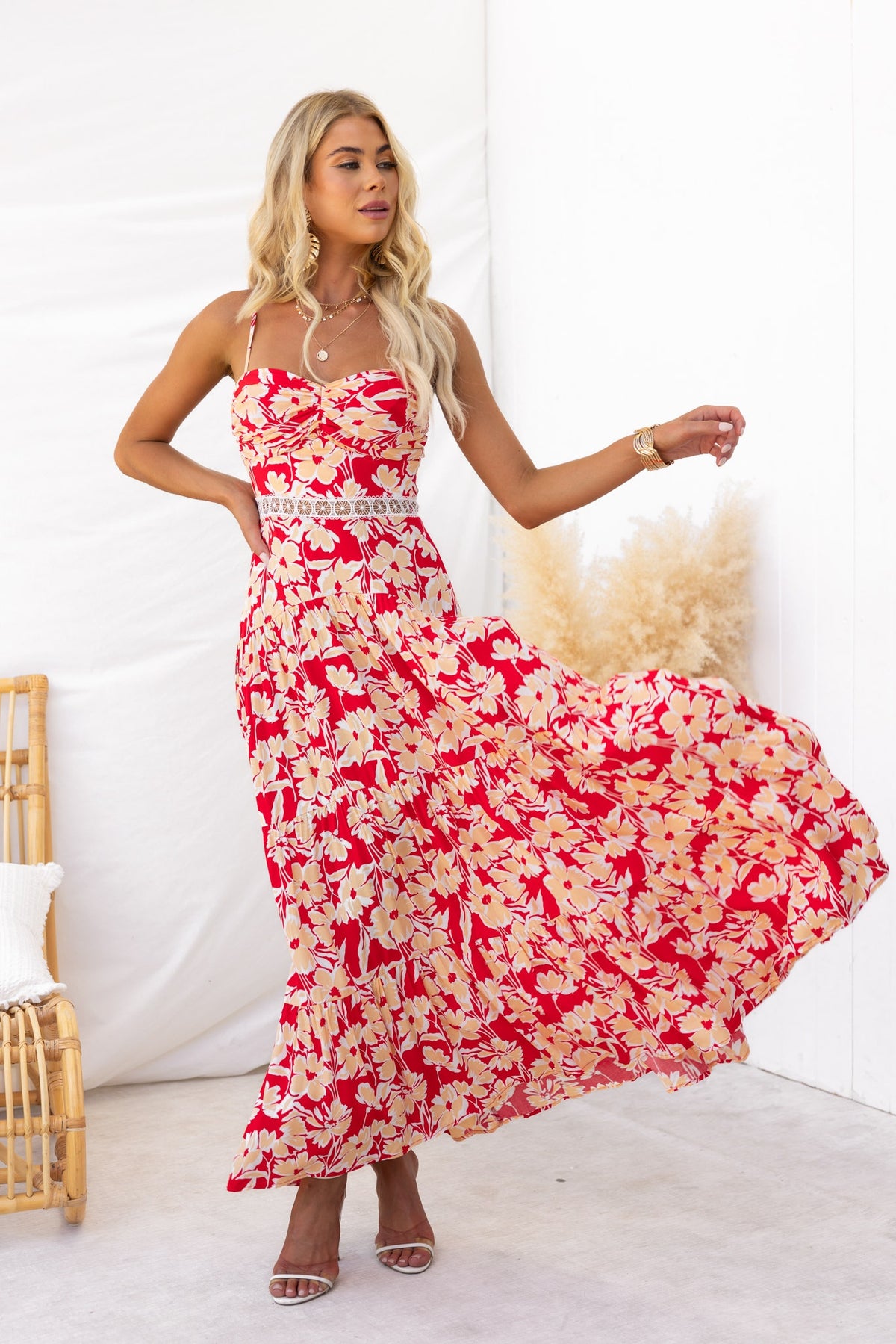 Model wearing a Vani Maxi Dress featuring a floral print, adjustable straps, and lace detail.