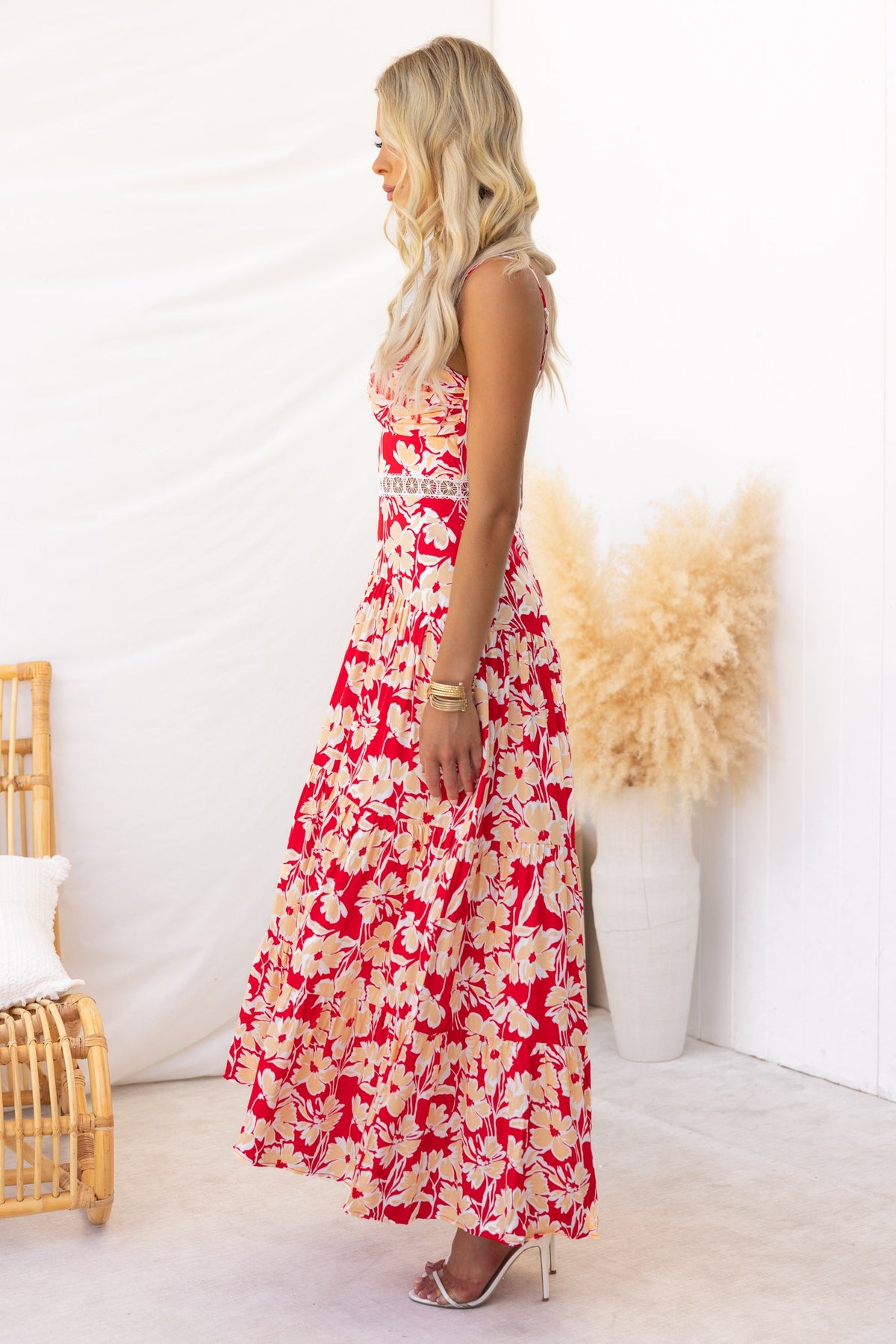 Side view of a floral print Vani maxi dress with adjustable straps, showcasing its elegant design and light material.