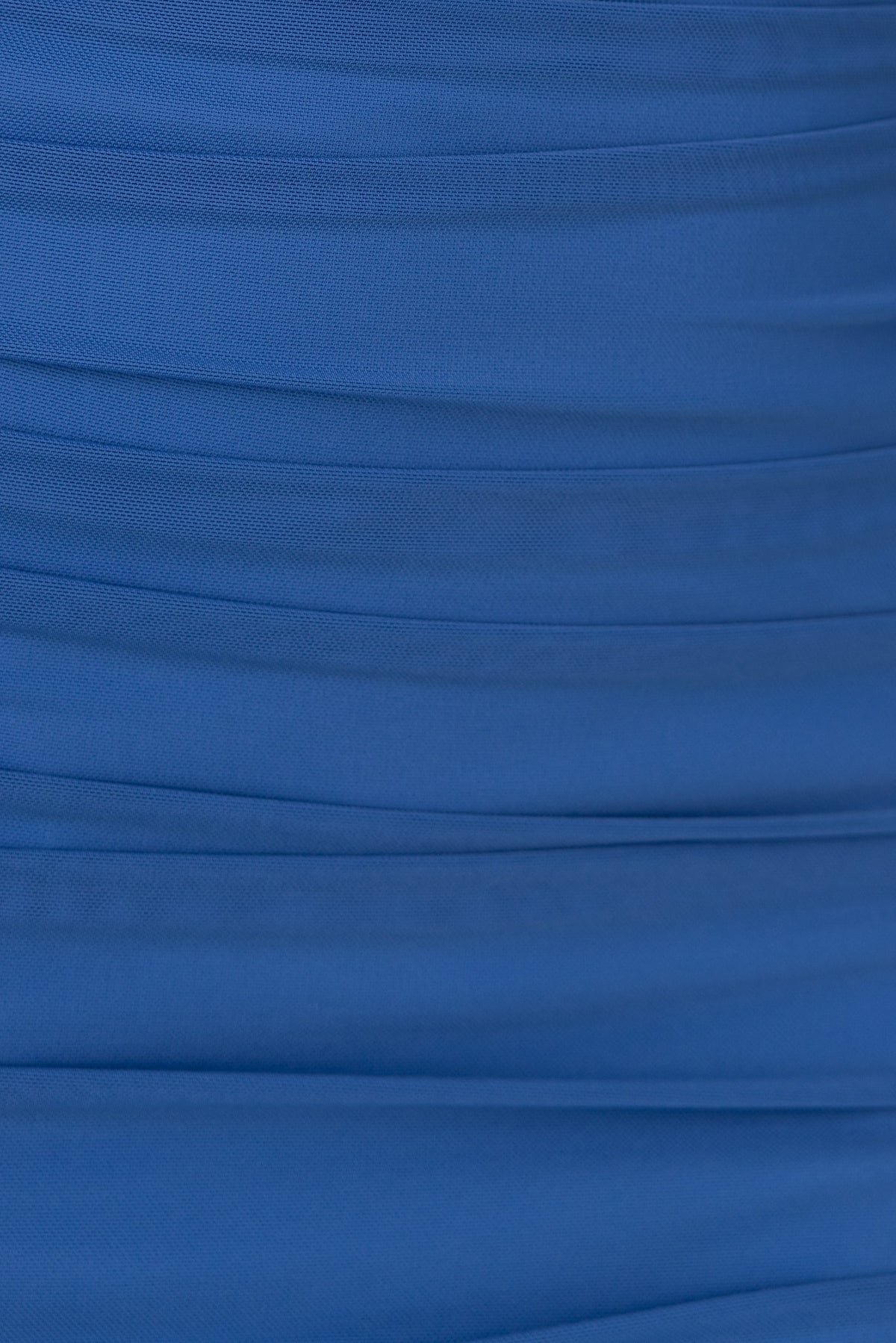 Close-up of textured blue fabric showcasing pleats and smooth material, ideal for a bodycon maxi dress.