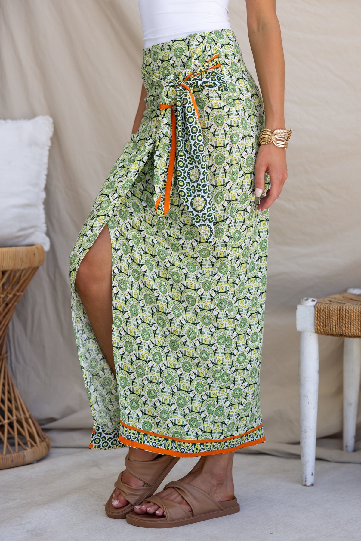 Tahnee Maxi Skirt featuring a wrap look, asymmetric hemline, and tie detail in vibrant green fabric.