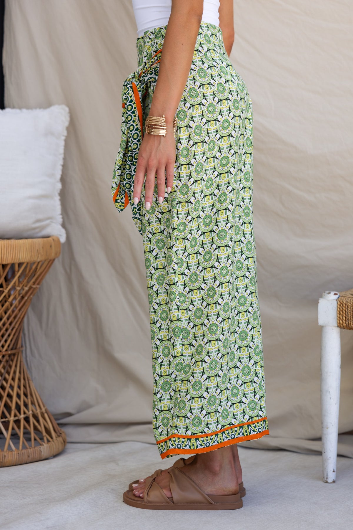 Side view of the Tahnee Maxi Skirt featuring a wrap design, mid-low waist, and colorful print with tie detail.