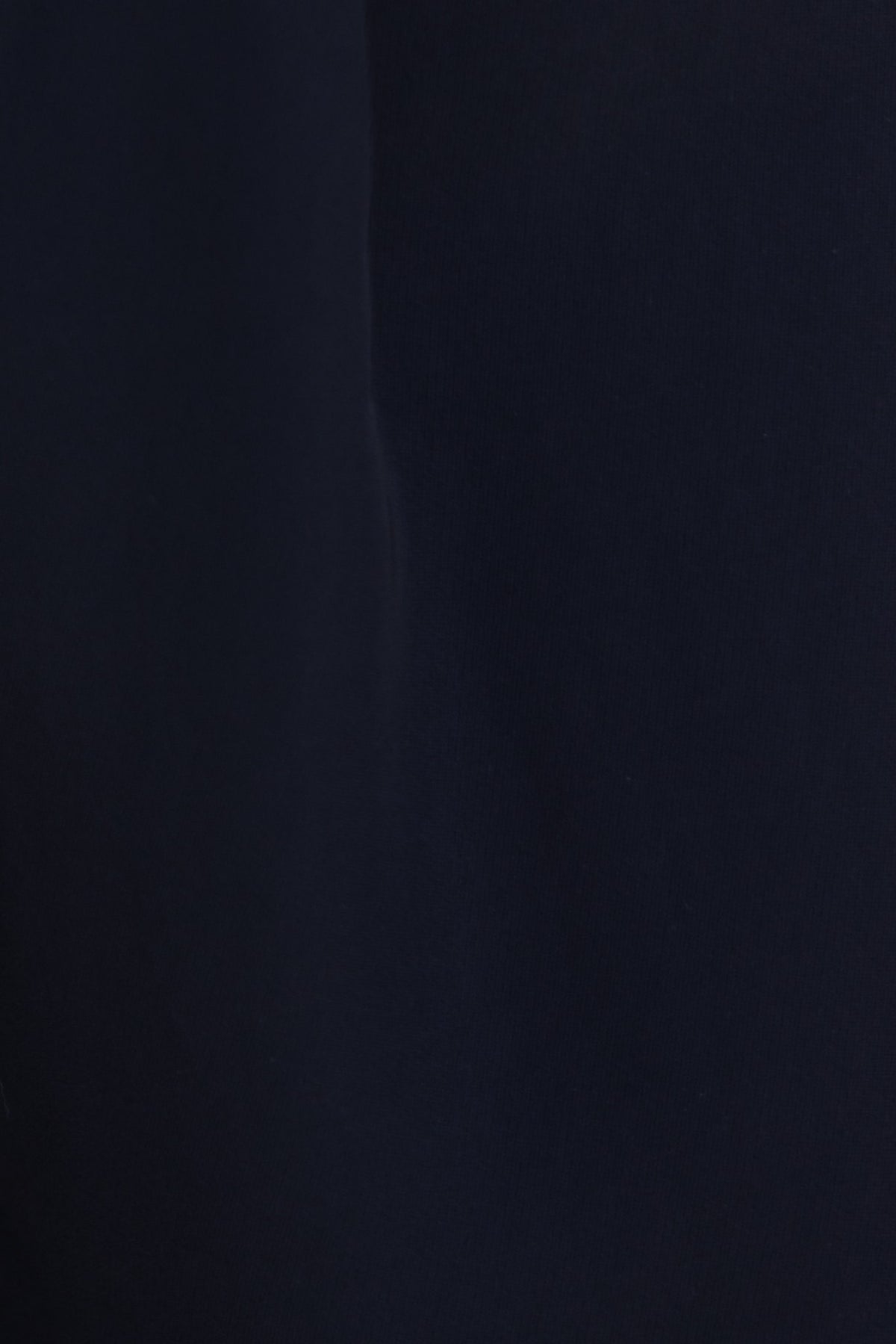 Close-up of black fabric texture of Lianna Pants featuring a smooth, non-stretch, mid-high waist design.