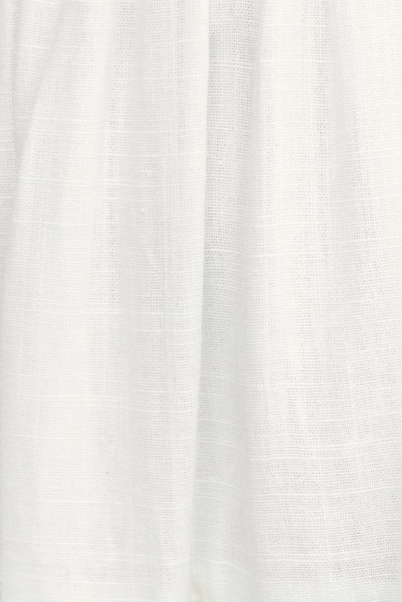 Close-up of lightweight, textured fabric in white, showcasing a linen look and feel for stylish clothing.