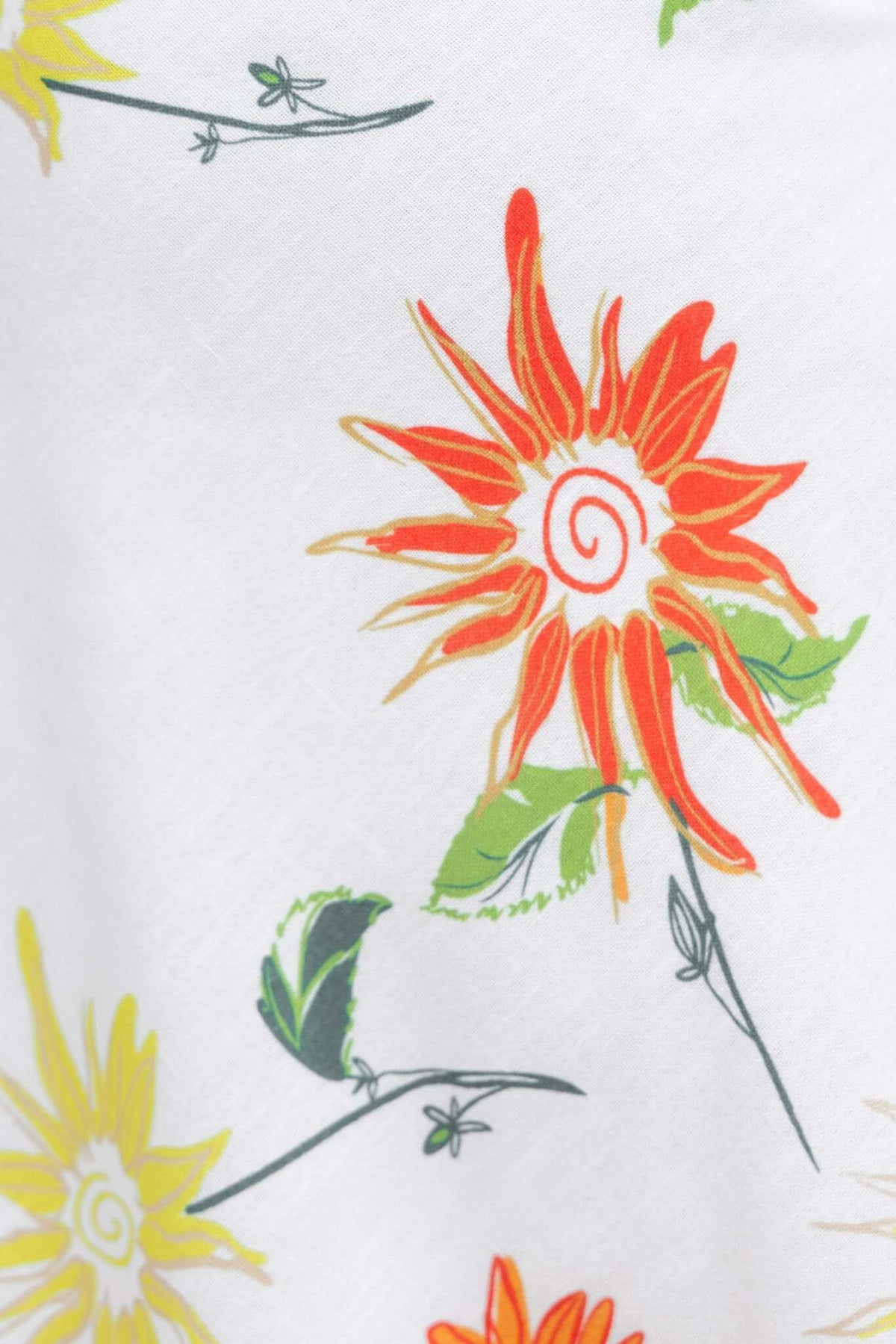 Colorful floral print featuring vibrant sunflowers in yellow and orange on a white background.