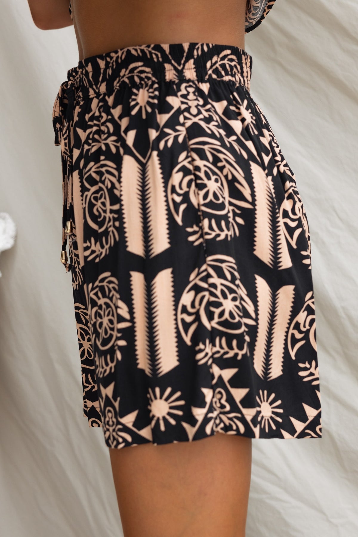 Women's ginger print shorts featuring mid-high waist, elastic waistband, and pockets, made from lightweight 100% rayon.