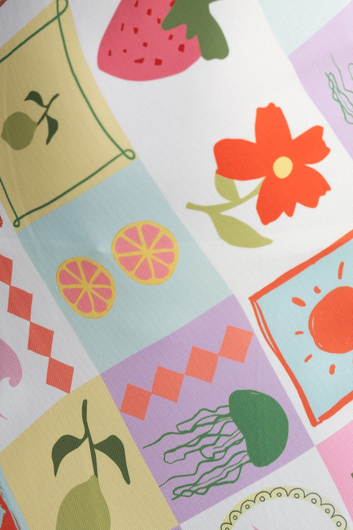 Colorful print featuring fruits and flowers on a fabric, perfect for a playful maxi dress design.