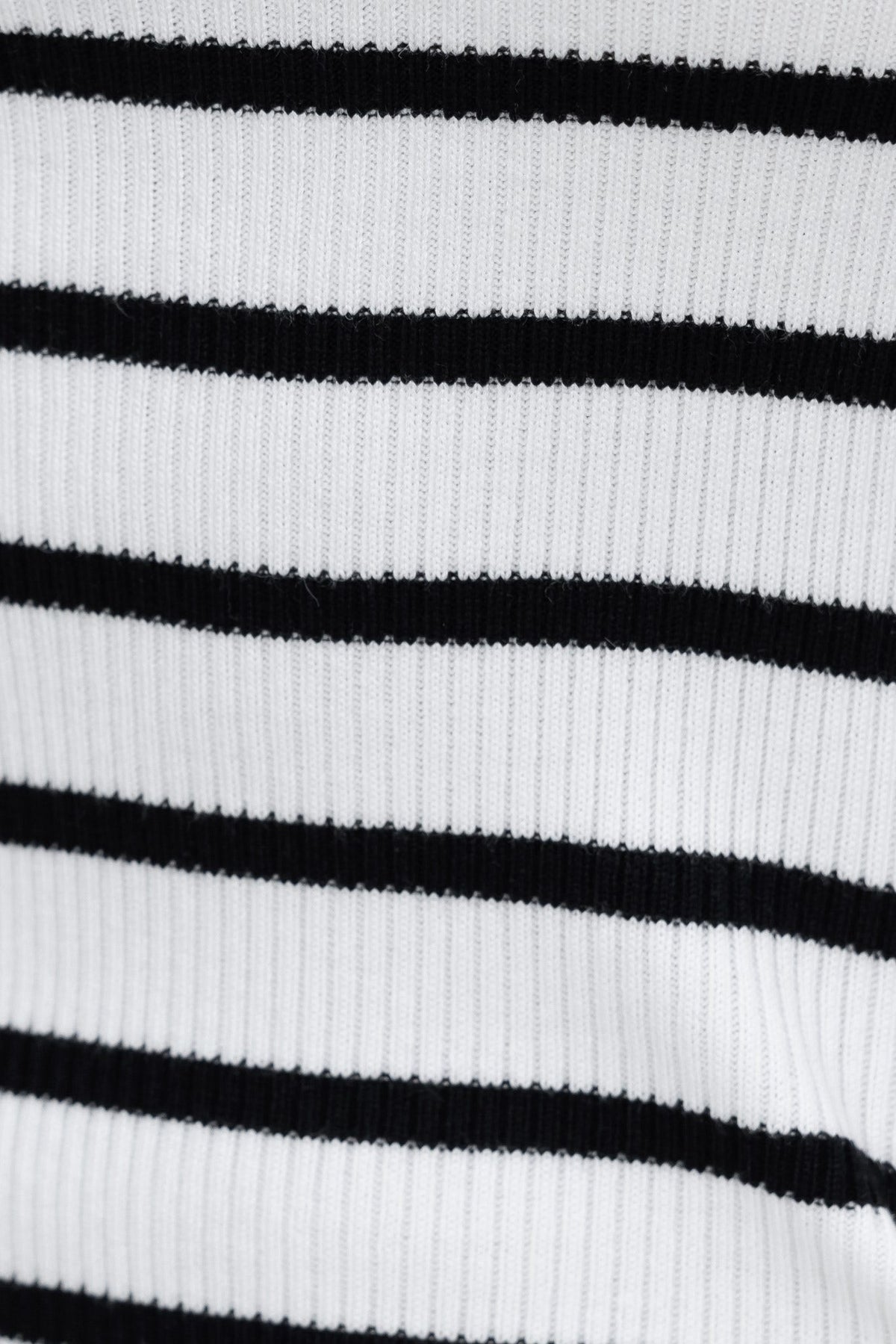 Close-up of ribbed knit fabric in black and white stripes, showcasing the texture and pattern for Rilie Maxi Dress.