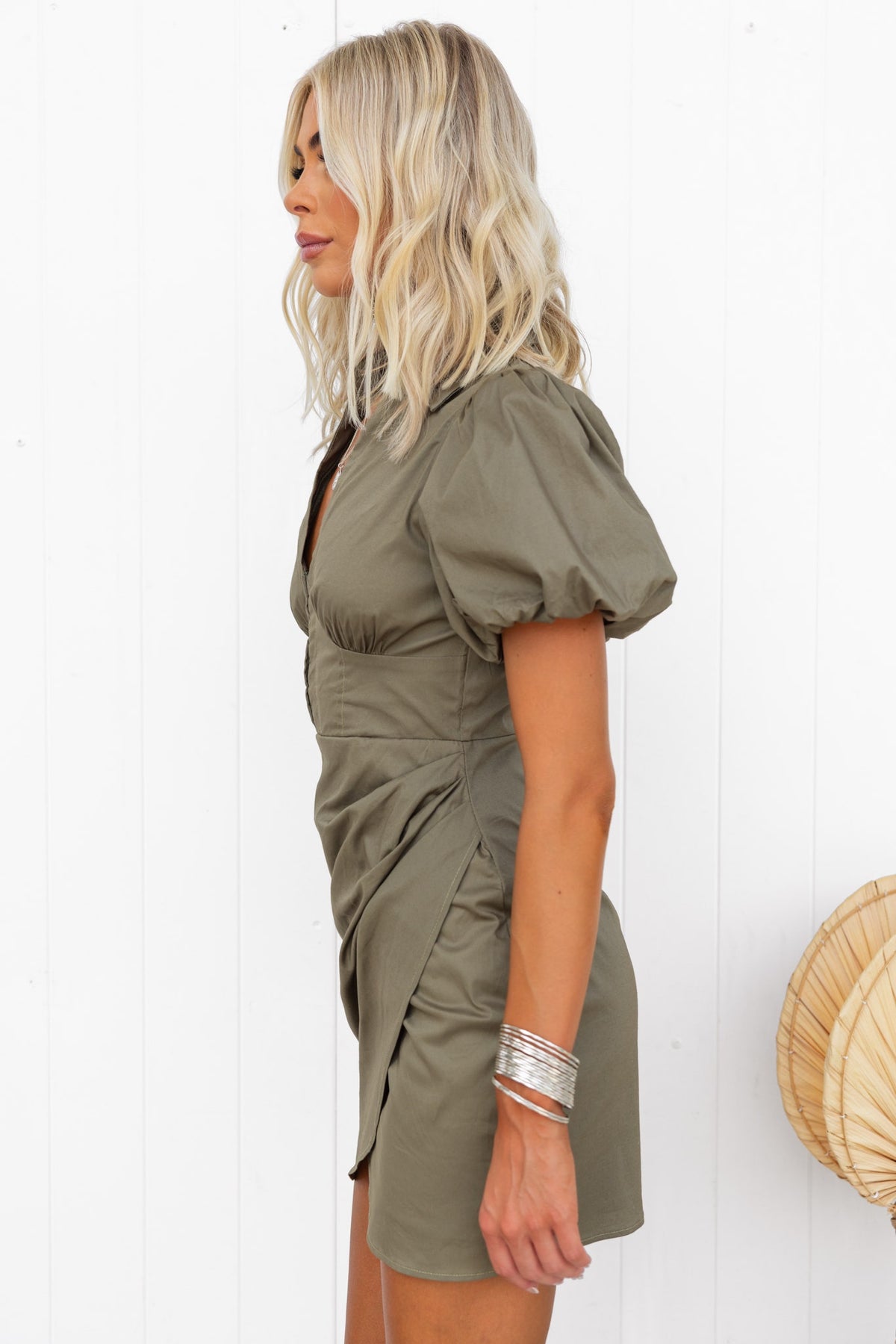 Lourde Dress in olive green, featuring puff sleeves, ruching detail, and a flattering mini length.