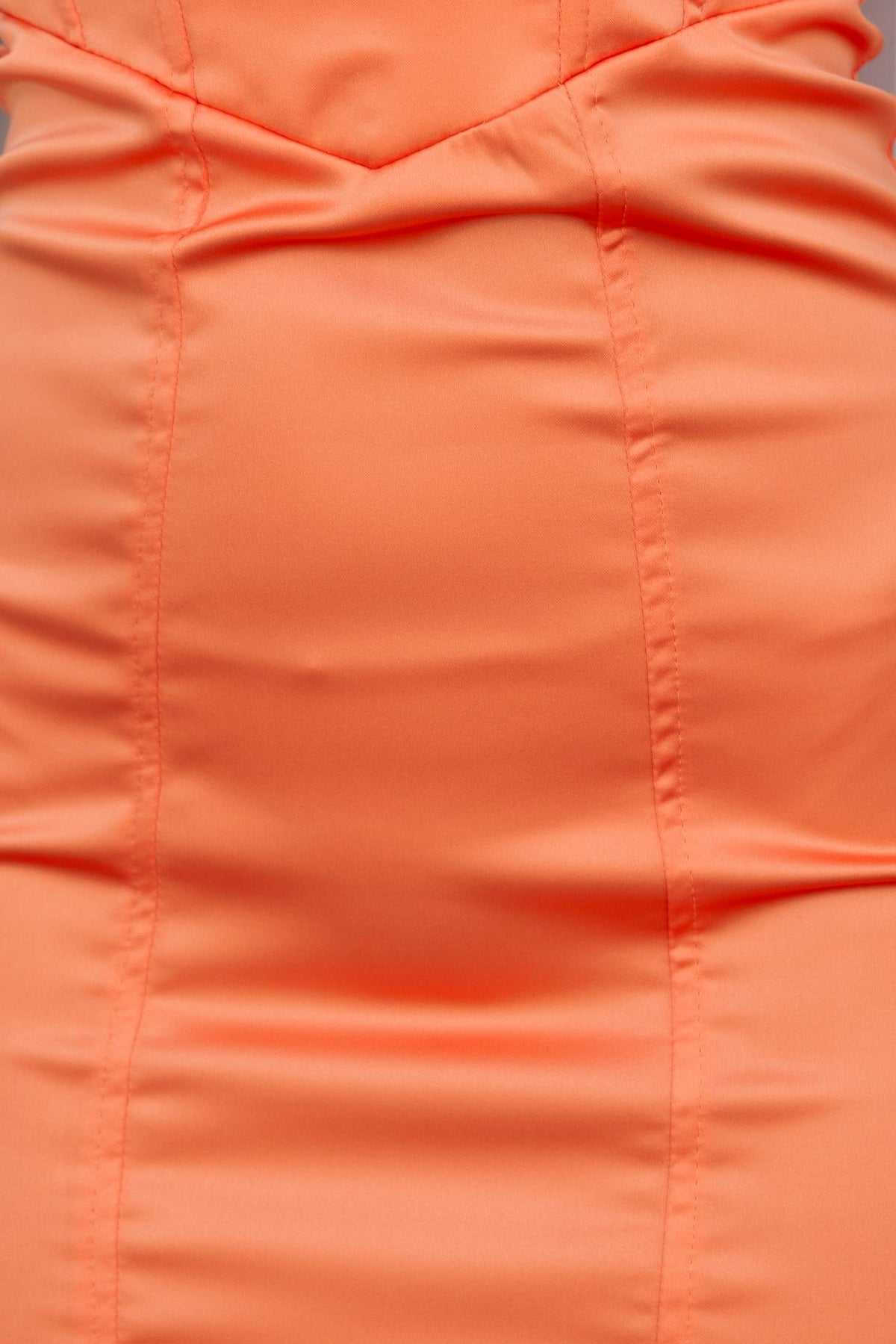 Close-up of the Jorden Dress showcasing its smooth, stretchy satin fabric in vibrant orange.