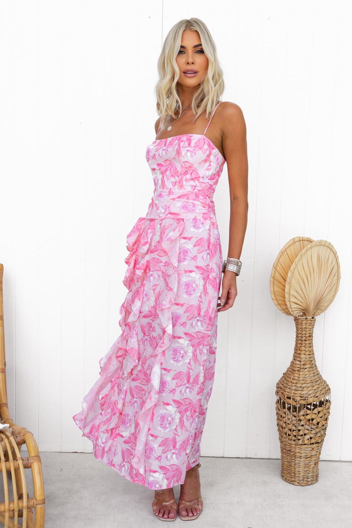 Floral Genovia Maxi Dress with adjustable straps and side split, styled on model against a minimalist background.