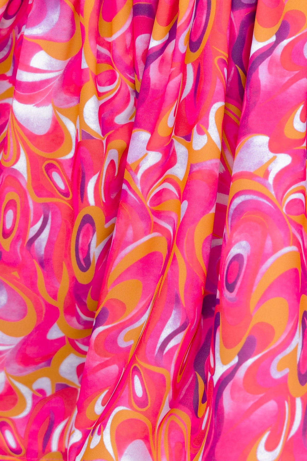 Close-up of vibrant pink and orange abstract print fabric on a Kensie playsuit, showcasing its colorful design.