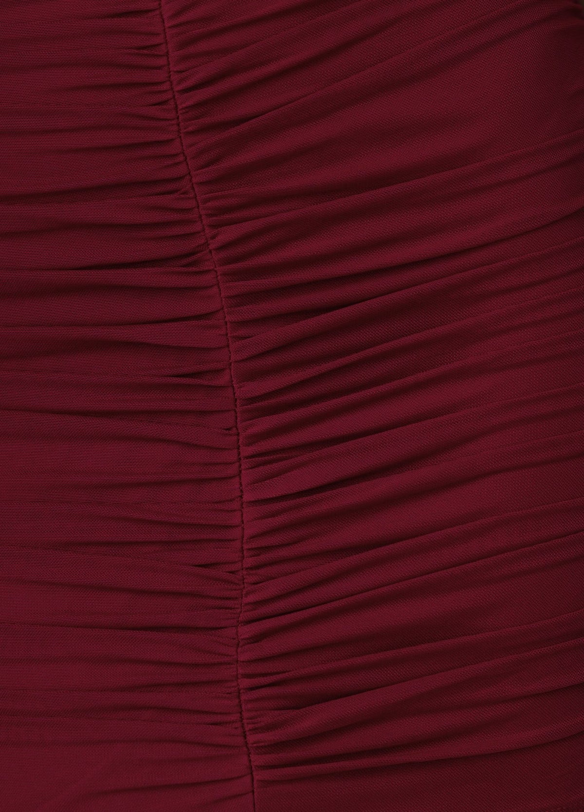 Close-up of burgundy mesh fabric featuring intricate ruching details on the Torrey Dress.