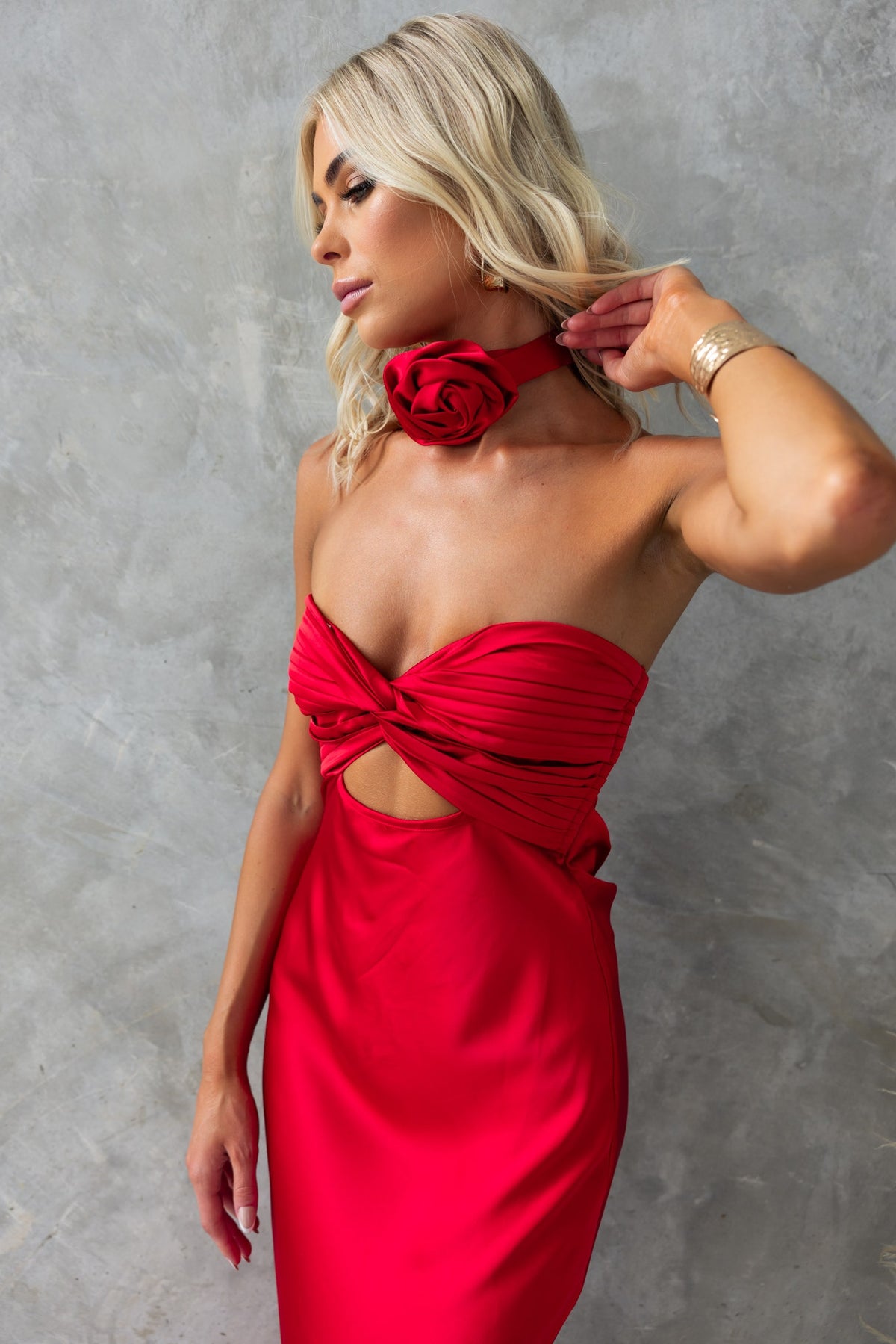 Red Lamoura Maxi Dress featuring a strapless design, cut-out detail, and removable floral brooch for elegant style.