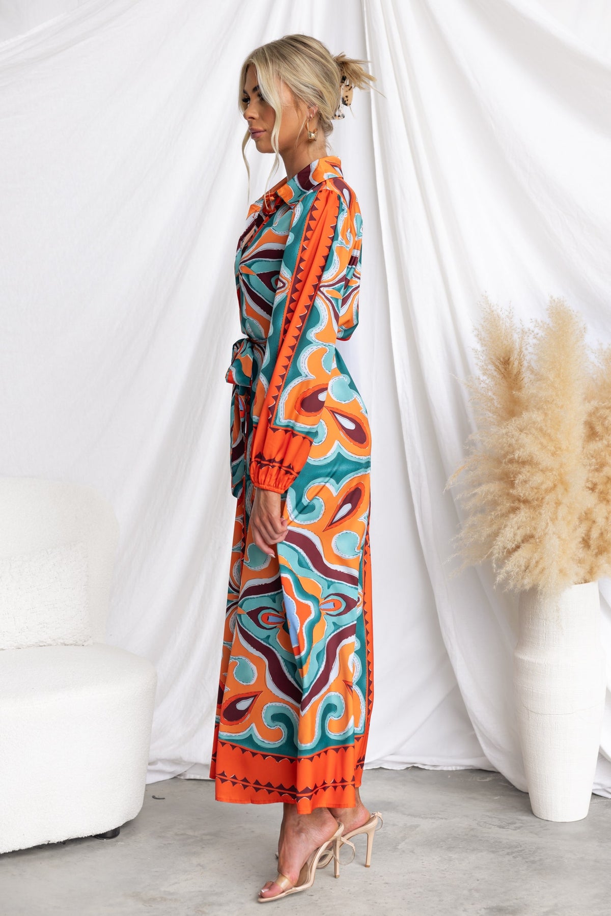 Namari Maxi Dress featuring an abstract print, collar, button-up front, and elastic sleeves in vibrant colors.
