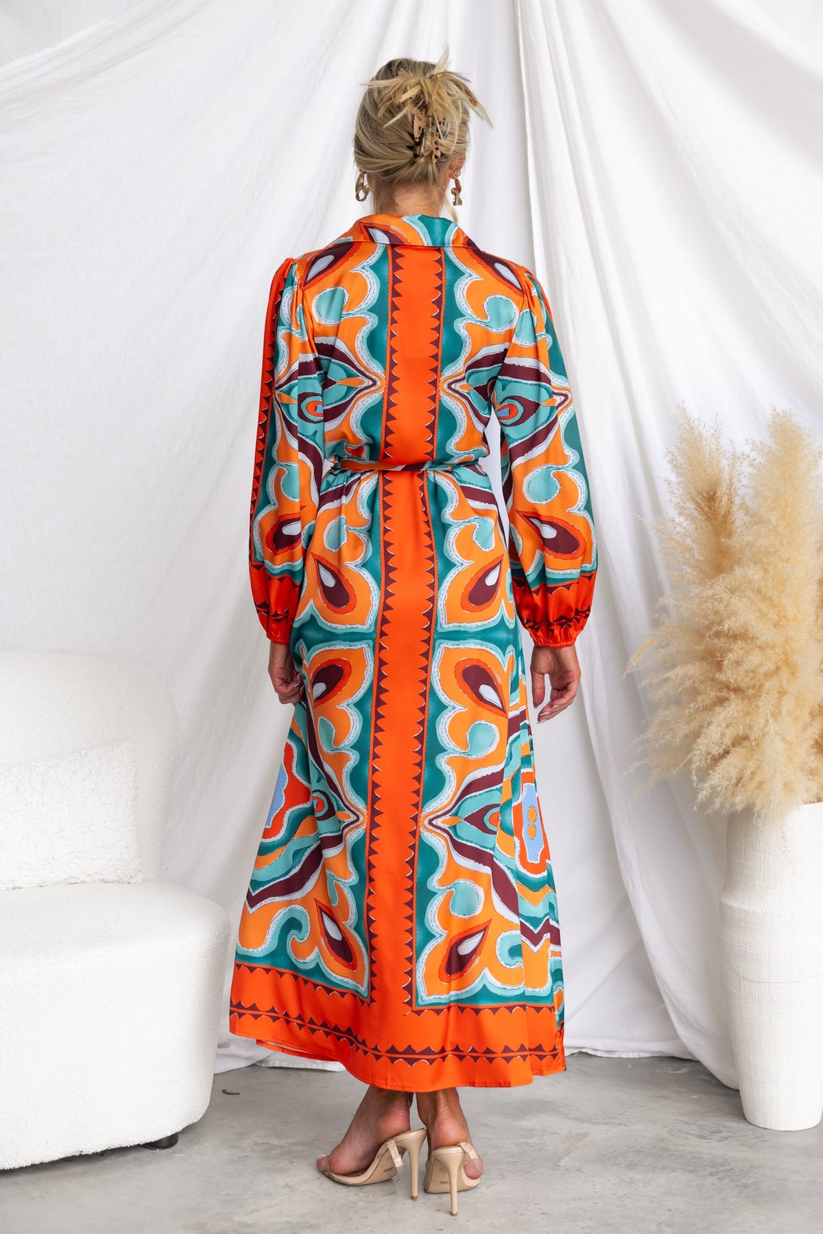 Back view of Namari Maxi Dress featuring abstract print in vibrant colors with elastic sleeves and fabric tie.