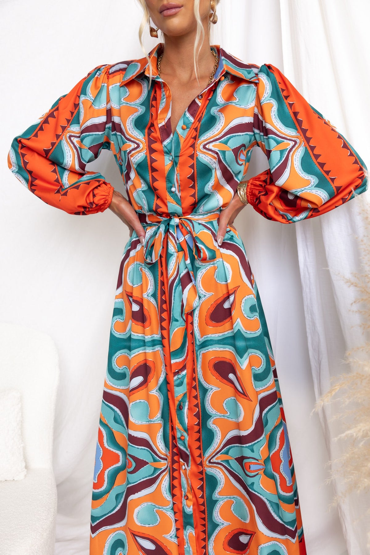Namari Maxi Dress featuring bold abstract print, button-up front, and elastic sleeves in vibrant colors.