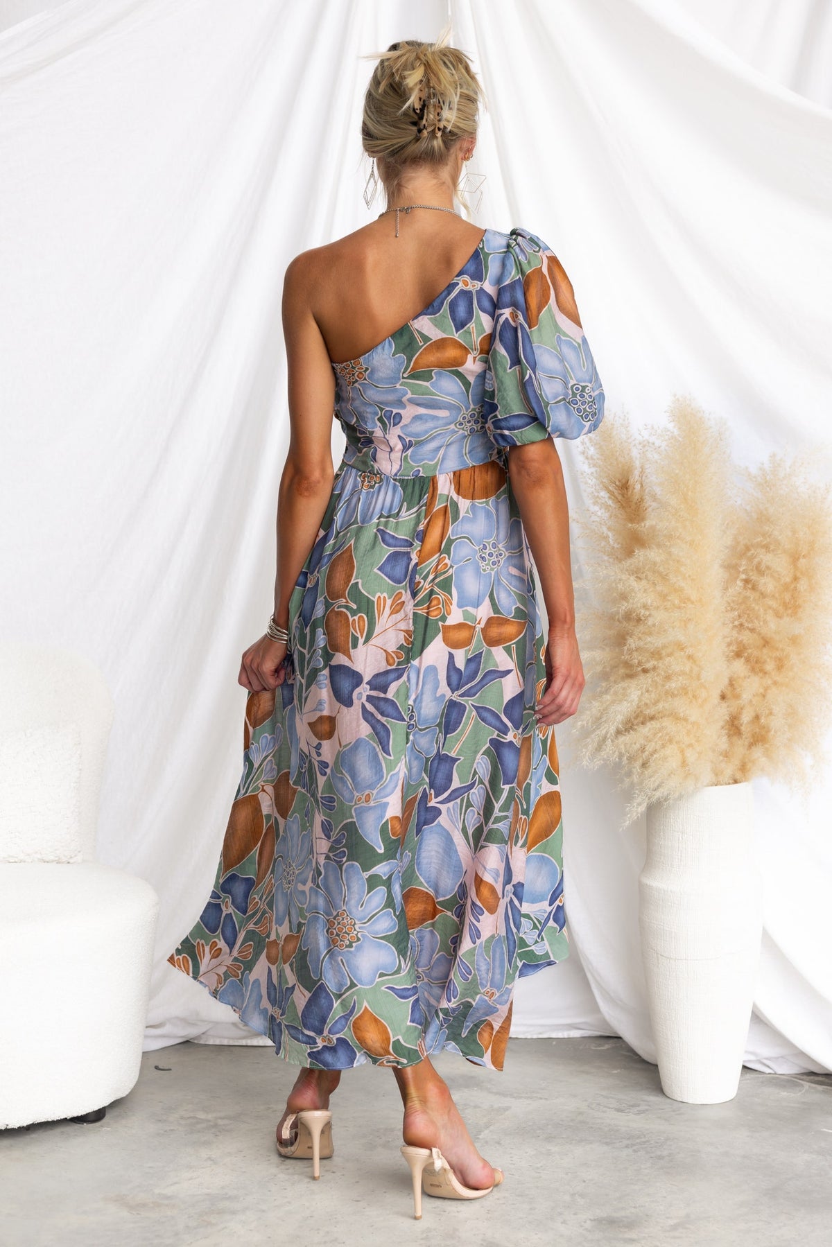 One-shoulder floral print midi dress with a flowy silhouette, showcasing a stylish and elegant back view.
