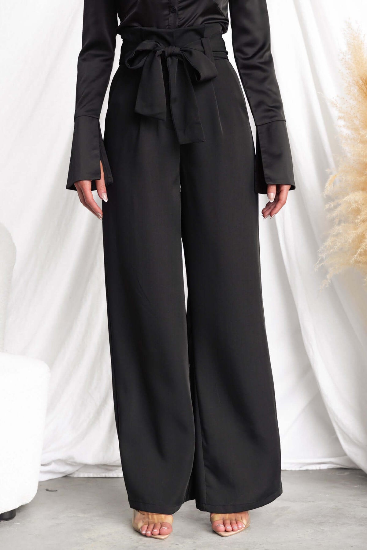Jaspin Pants featuring a black paper bag waist, removable tie, and wide legs, perfect for stylish comfort.