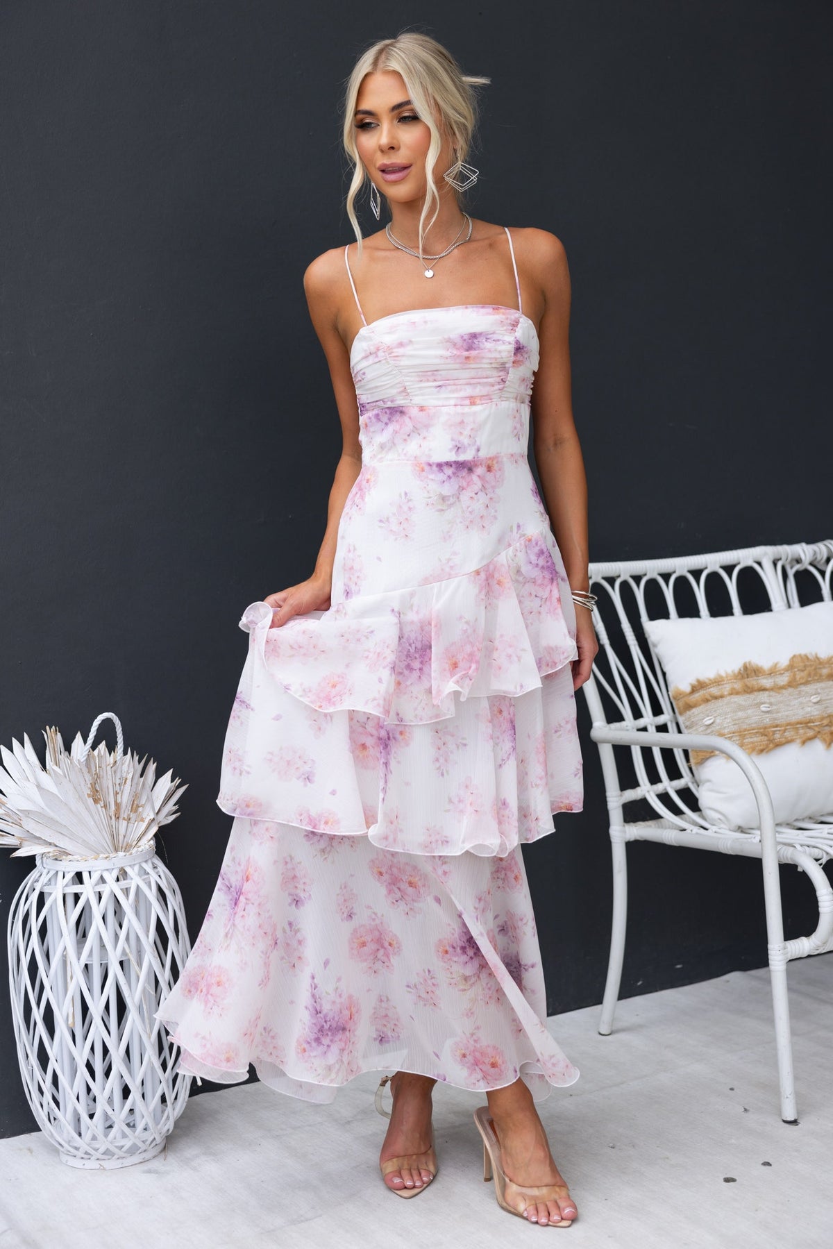 Saphina Maxi Dress: floral chiffon dress with adjustable straps and multi-tier ruffle skirt styled in a modern setting.