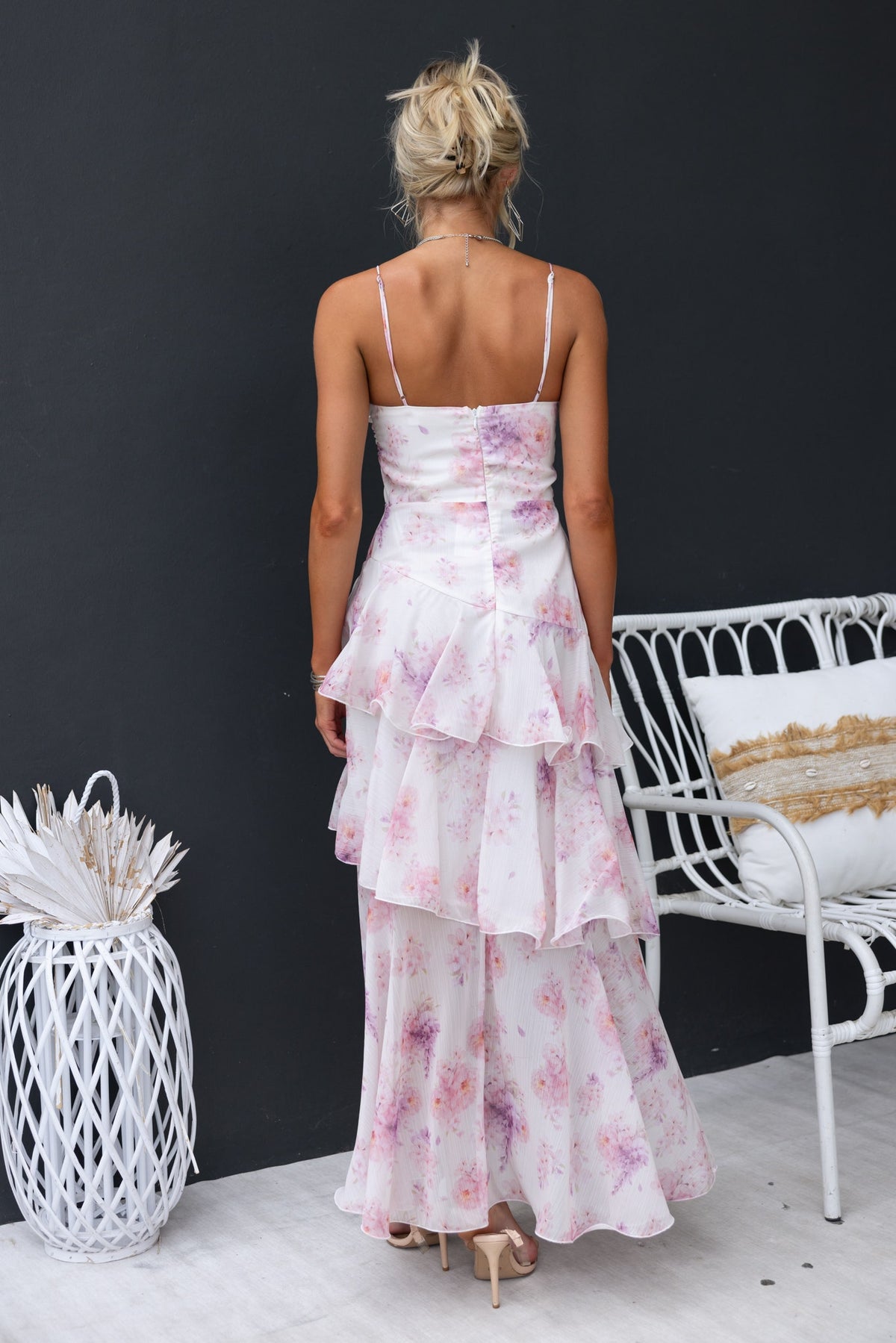Back view of Saphina Maxi Dress featuring floral pattern, adjustable straps, and multi-tier ruffle skirt.