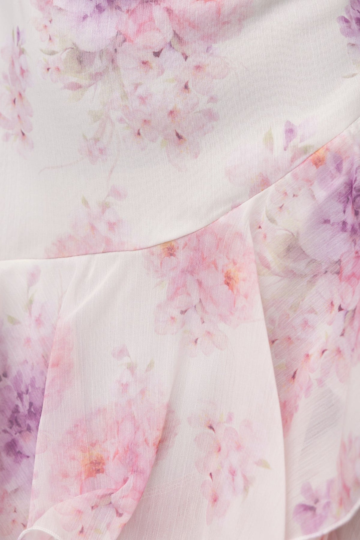Close-up of floral chiffon fabric featuring pink and purple blossoms on the Saphina Maxi Dress.