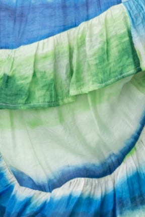 Close-up of the tie-dye fabric featuring blue and green hues with ruffle detail for the Fondar Maxi Dress.