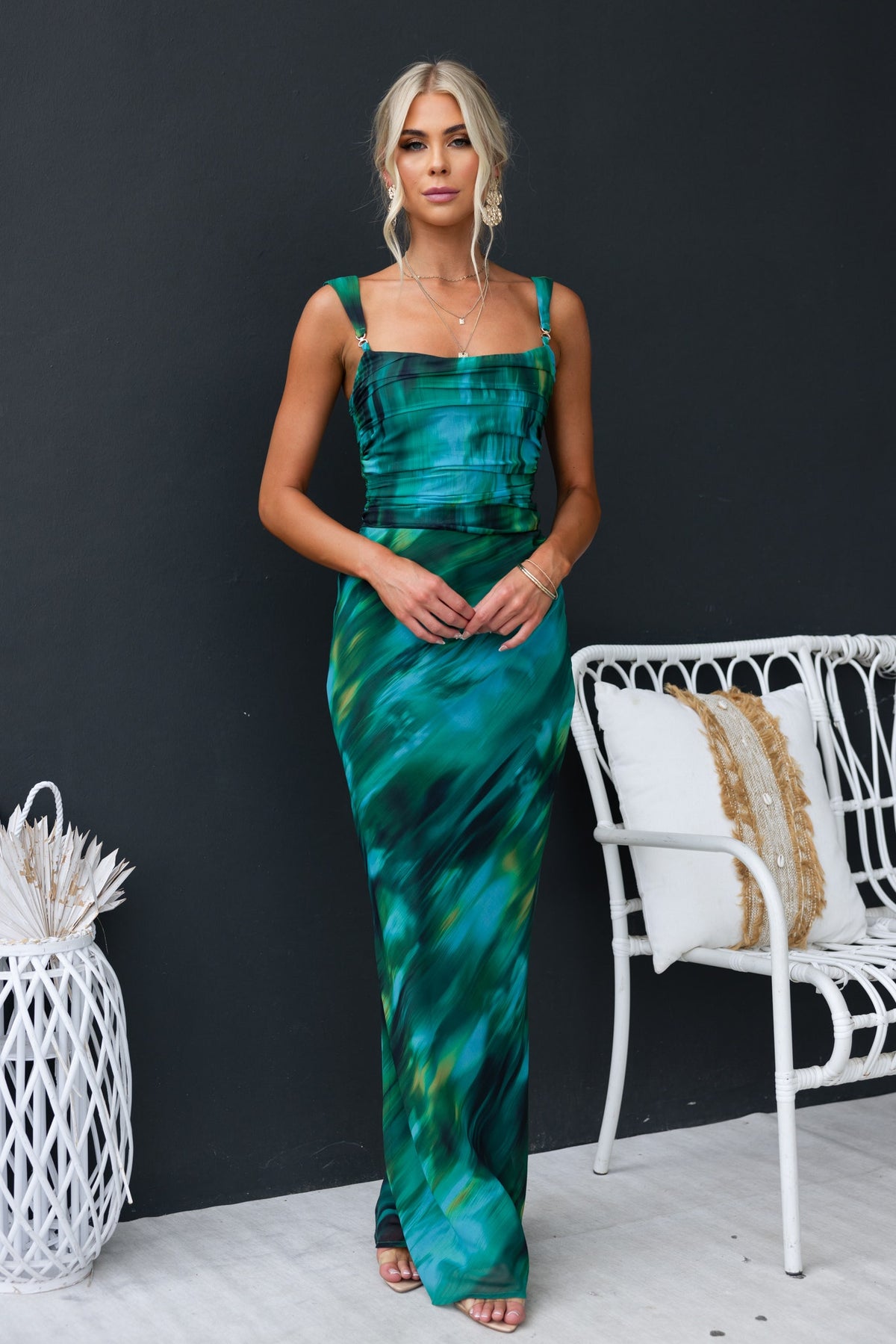 Taylah wearing the Voyage Maxi Dress with gold hardware, showcasing a vibrant green print and a chic, elegant silhouette.
