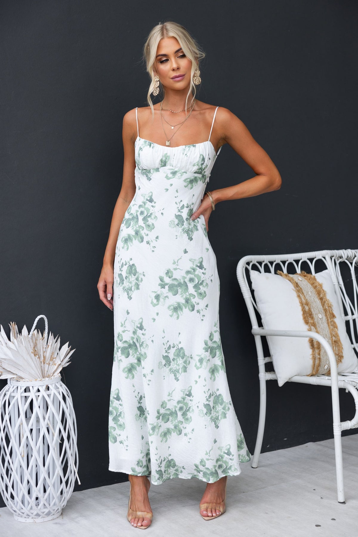 Model wearing Freyda Maxi Dress, a floral print dress with adjustable straps and cut-out back, styled in a modern setting.