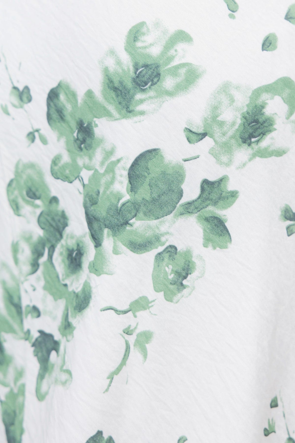 Close-up of floral print on Freyda Maxi Dress featuring green hues on a light background.