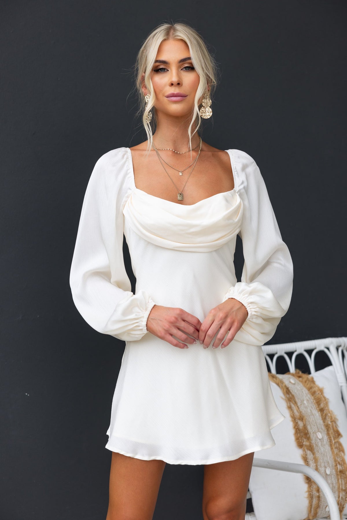 Averi Dress in white with puff sleeves and textured bust overlay, featuring an invisible back zip and elegant fit.