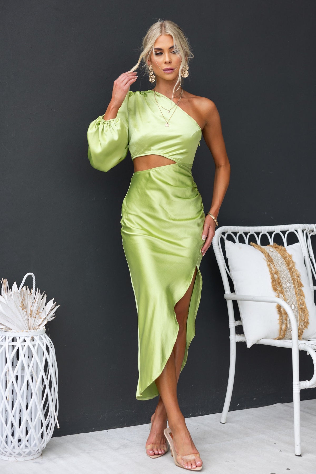 Jeyne Midi Dress in green satin, one-shoulder style with cut-out at waist and asymmetric hem, model wearing size 6/XS.