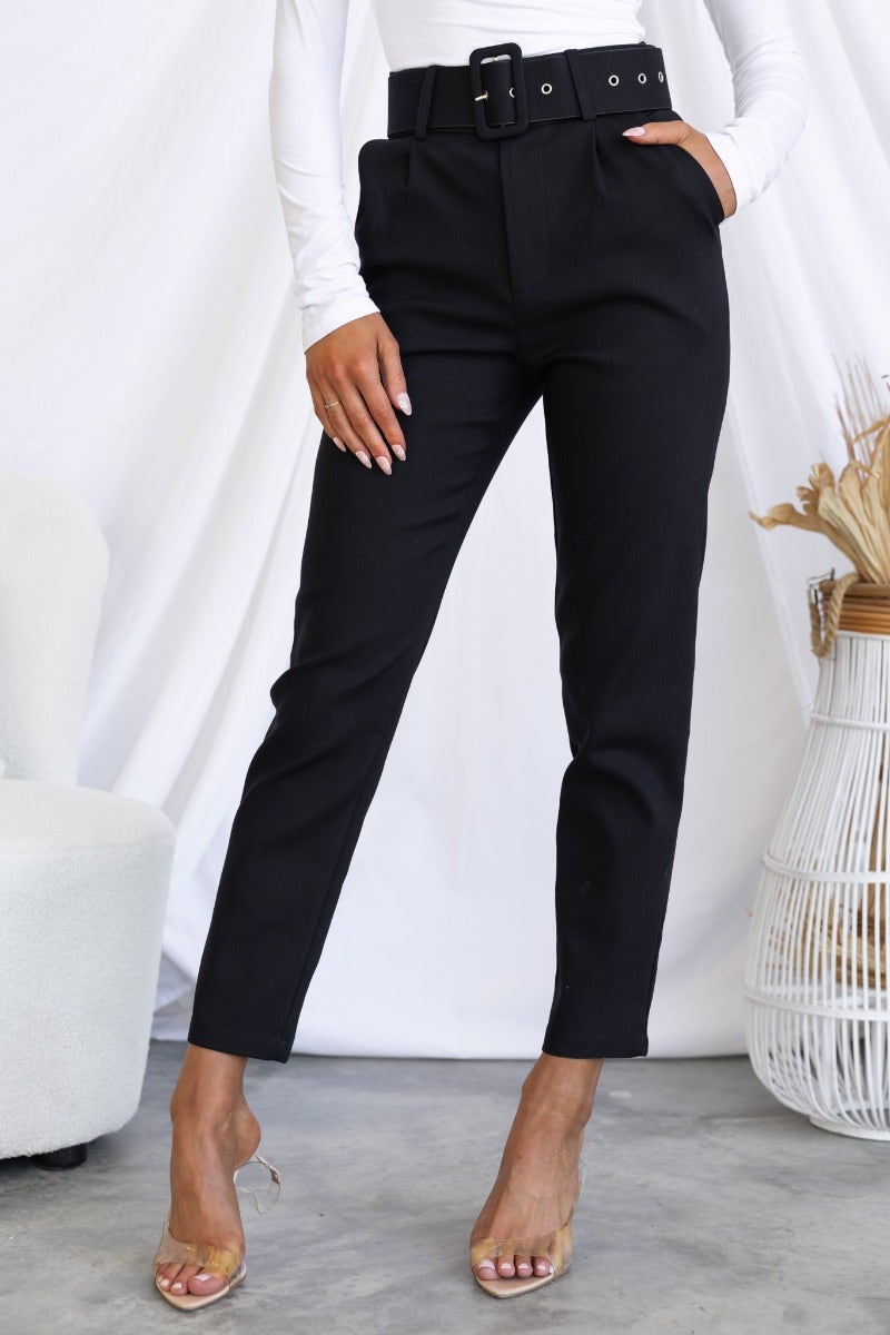 Stylish black Kaniva pants with a removable belt and front pockets, designed for a standard slim fit.
