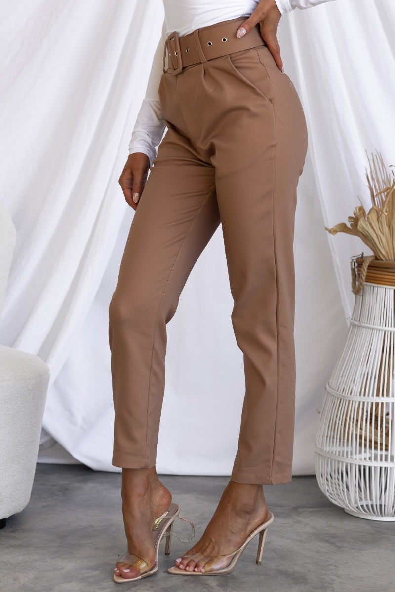 Stylish Kaniva Pants in brown, featuring a removable belt and front pockets, showcased in a slim fit.