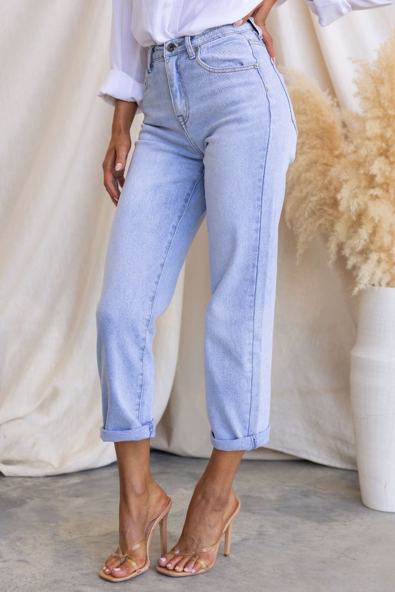 Isoka Jeans in light wash with mid-high waist fit, front and back pockets, and rolled cuffs for a stylish look.