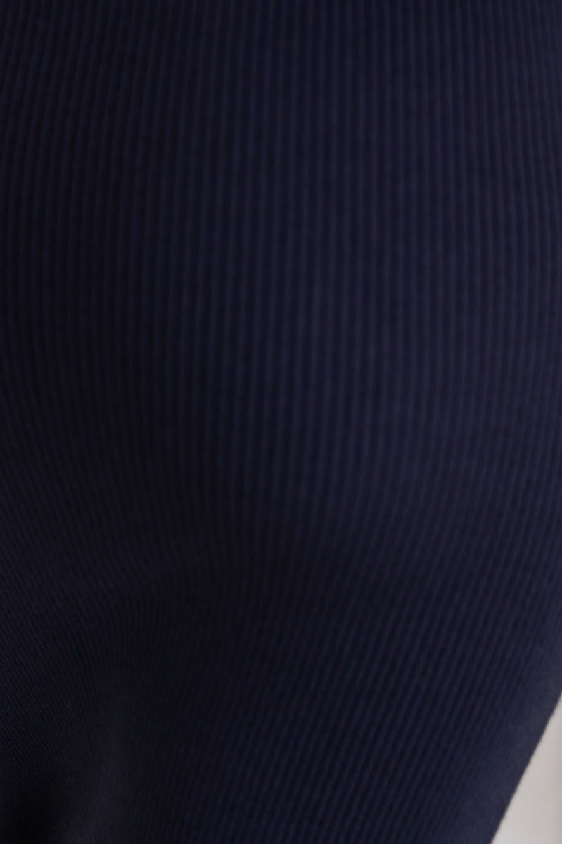 Close-up of navy ribbed knit fabric of Ulina Midi Dress, showcasing its texture and stretch material.