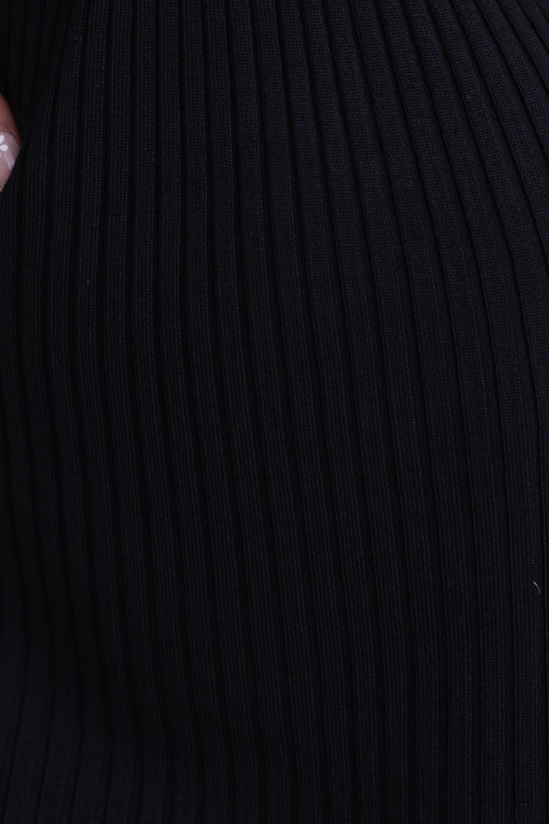 Close-up of black ribbed fabric texture of Keshy Maxi Dress, showcasing its stretch and detailed design.