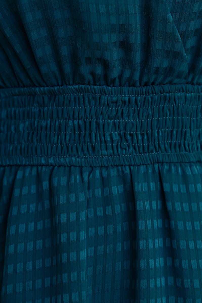 Close-up of Briena Midi Dress showing lightly textured teal fabric and smocked waistband.